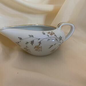 Noritake China white porcelain with gold trim and a floral pattern creamer